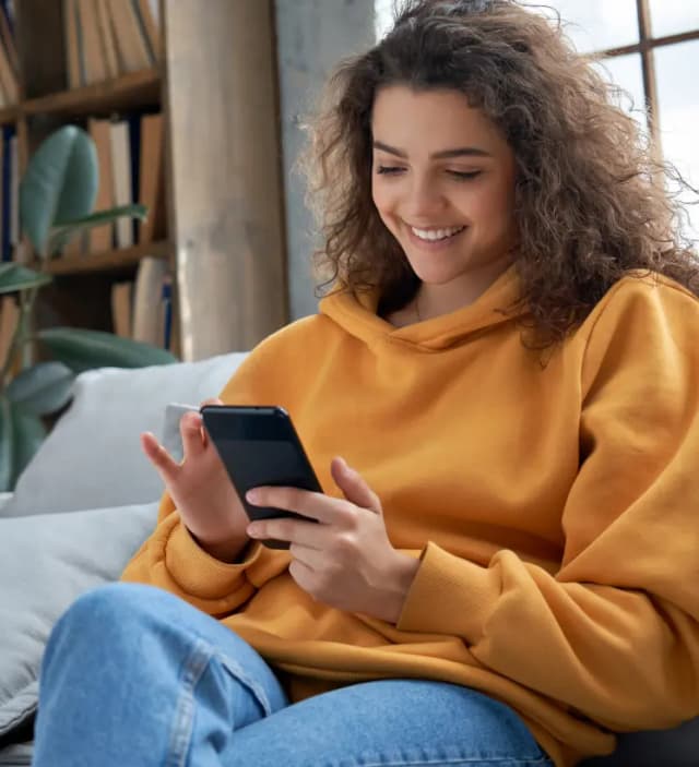 Smiling woman holding a smartphone